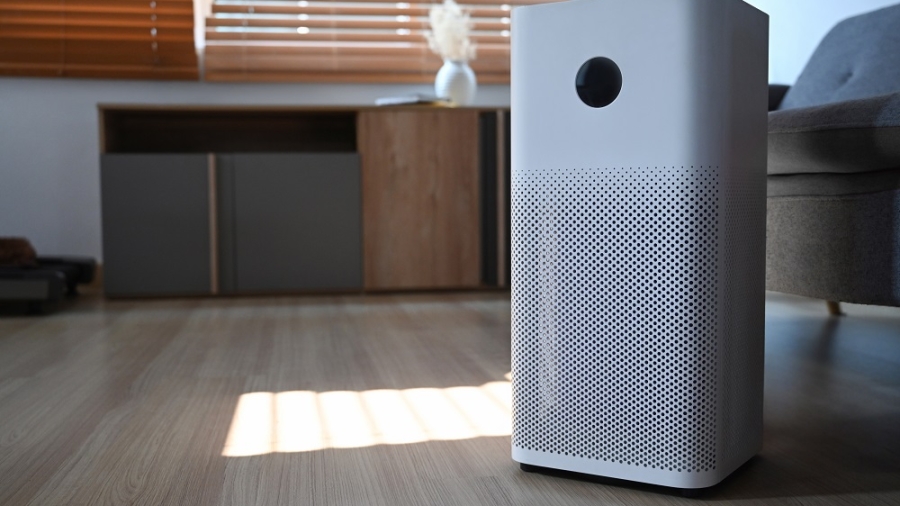 Indoor Air purifier on wooden floor in living room for filter and cleaning removing dust PM2.5 and virus.