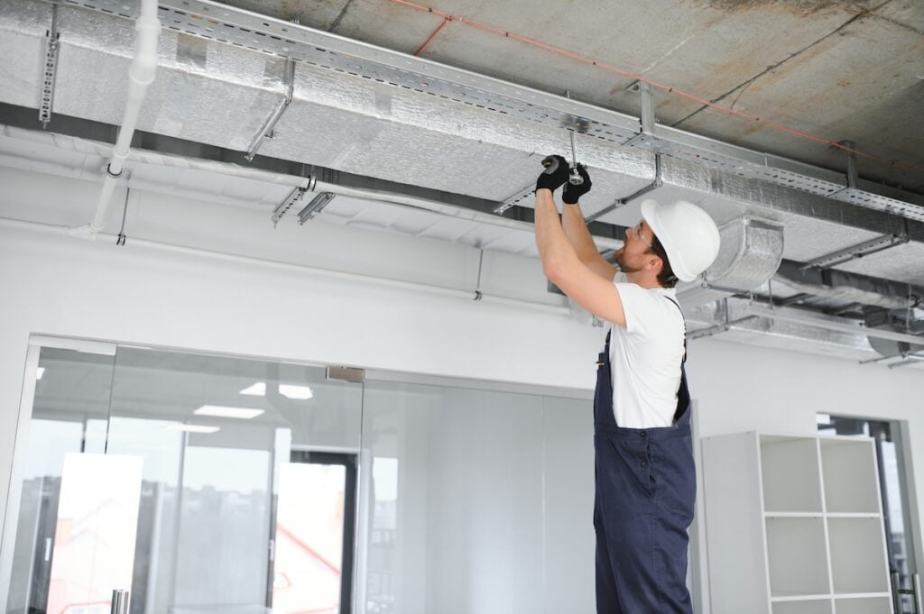 ventilation system installation and repair service. hvac technician at work. banner copy space.