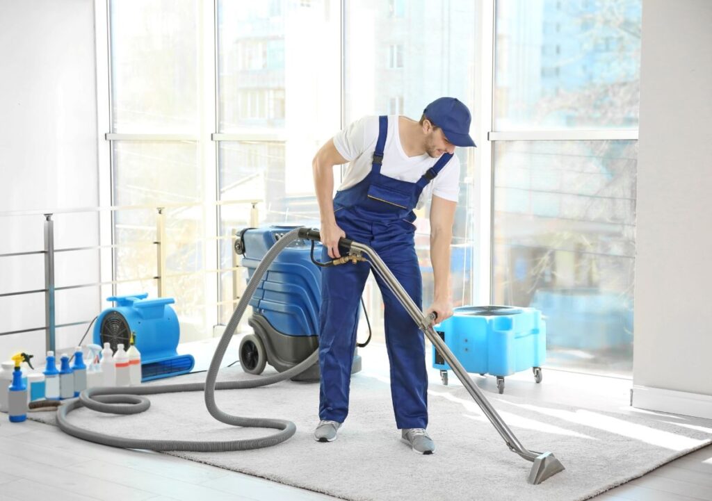 apartment building cleaning services man removing dirt from grey carpet