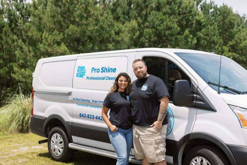 apartment building cleaning services woman and man standing next to each other hugging white van