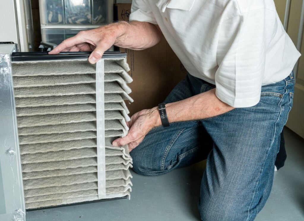 best air filter for home man changing filter
