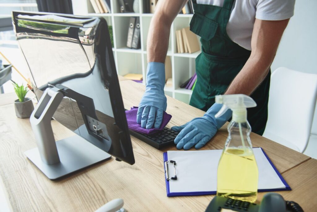office cleaning young man cleaning office table
