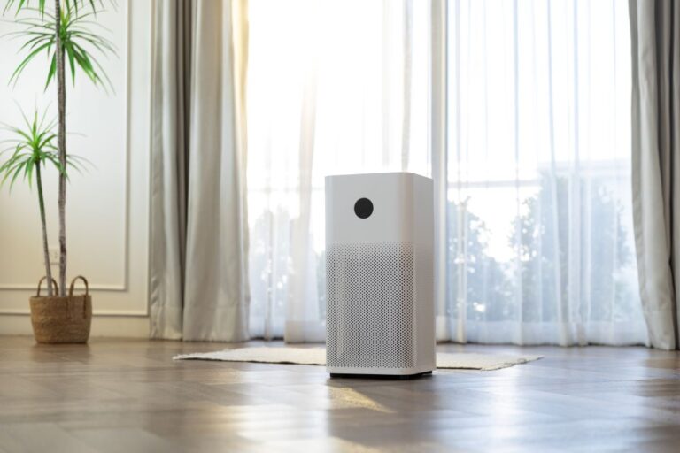 Air purifier in bright living room by large window