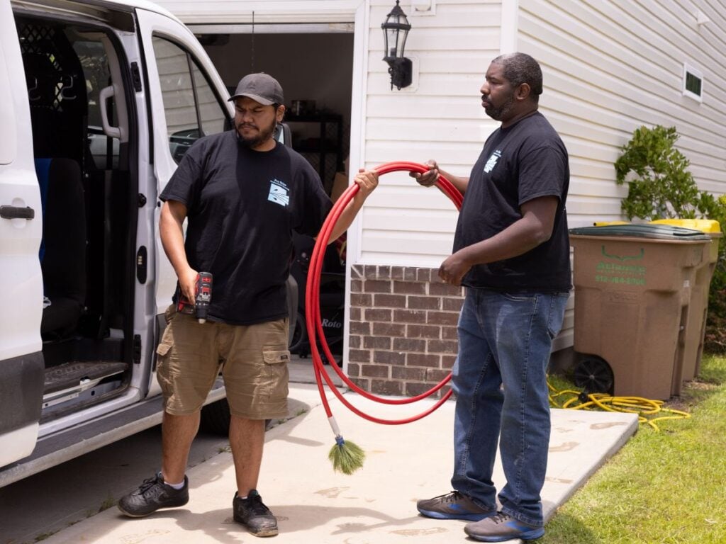 is air duct cleaning worth it Pro Shine workers outside of house