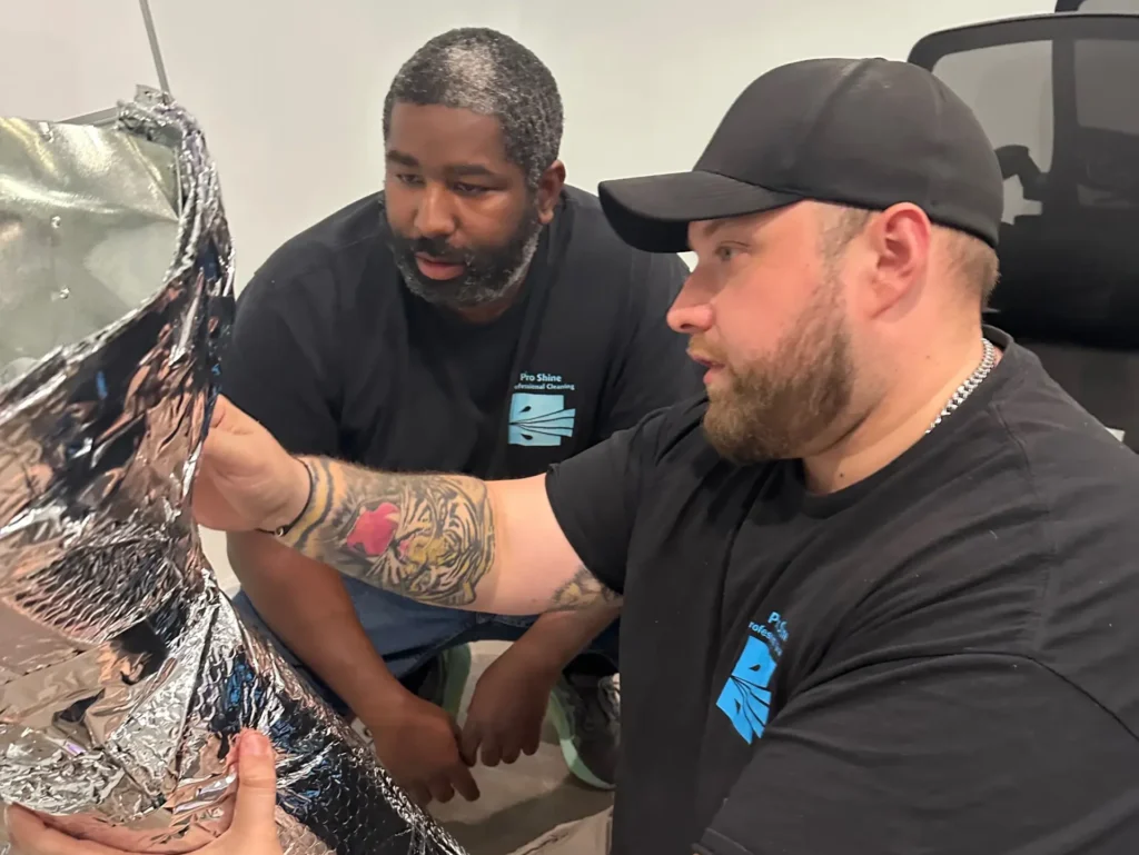 air duct cleaning business two workers organizing duct galvanized