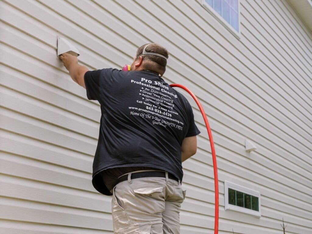 pro shine worker cleaning wall vent