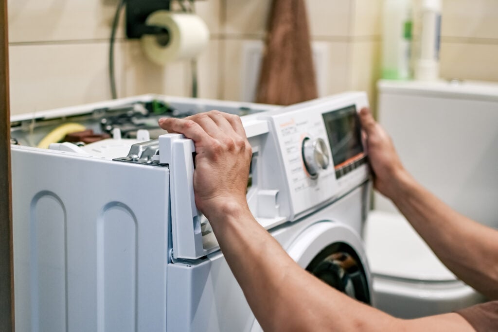 man fixing washing machine