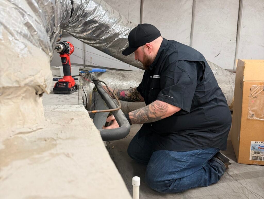 how many air ducts are in a house guy wearing black shirt fixing HVAC